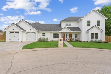 Modern farmhouse with fence, concrete driveway, b