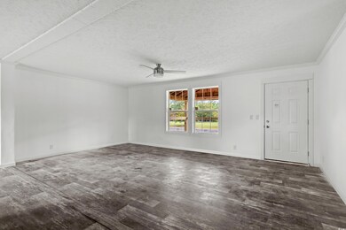 Unfurnished living room featuring wood finished fl