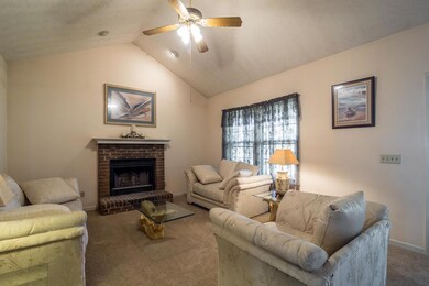 Living room with cathedral ceiling and fireplace
