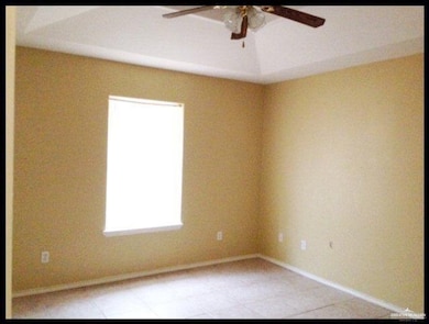 Unfurnished room with a ceiling fan, baseboards, and light tile patterned floors