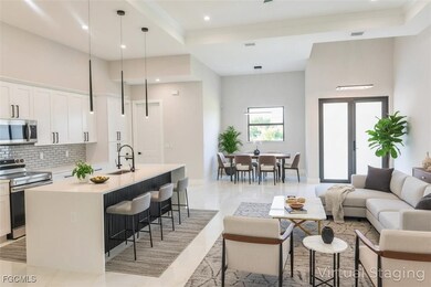 Living room with recessed lighting, a tray ceiling, and crown molding