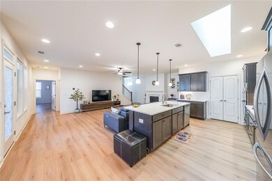 Kitchen with a sink, open floor plan, light wood-s