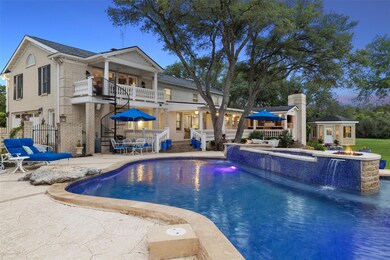 Pool at dusk featuring an outdoor structure, a pa