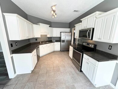 Kitchen featuring stainless steel appliances, rail