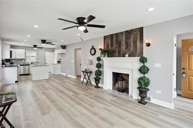 Living room with ceiling fan and light hardwood fl