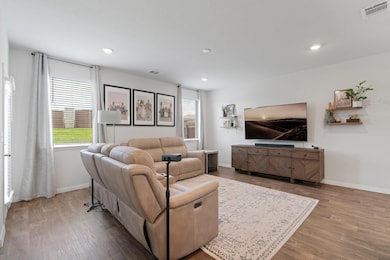 Living room with wood finished floors and recesse