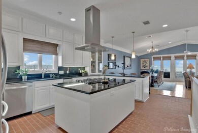 Kitchen with white cabinetry, hanging light fixtur