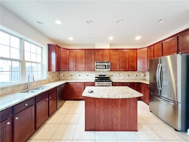 Kitchen featuring light stone counters, a kitchen 