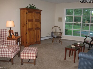 Step down, formal living room with beautiful bow window overlooking park-like grounds.