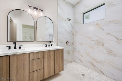 Full bath featuring double vanity, a sink, and a t
