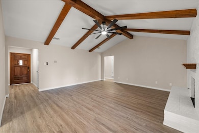 Unfurnished living room featuring a fireplace and light wood-style flooring