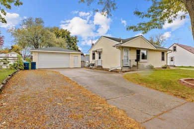 Beautiful concrete driveway and extra parking strip to the side with a huge 2 car garage!