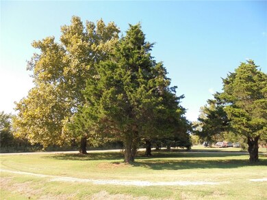 Circle drive with mature trees.