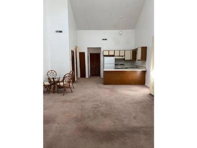Kitchen with freestanding refrigerator, a towering