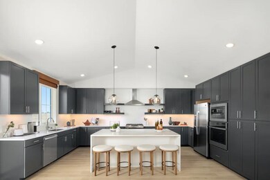 Kitchen with vaulted ceiling and pendant lighting
