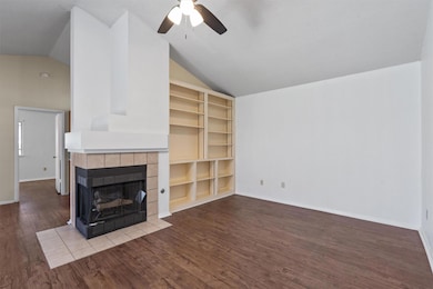 Unfurnished living room with a tiled fireplace, a