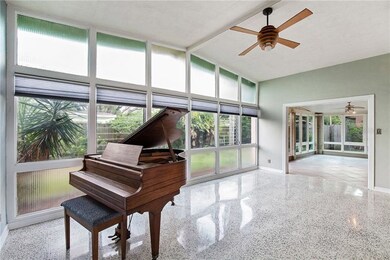 Light beams through this living room with tall cei