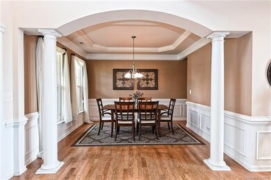 Entry featuring hardwoods and open to the dining a