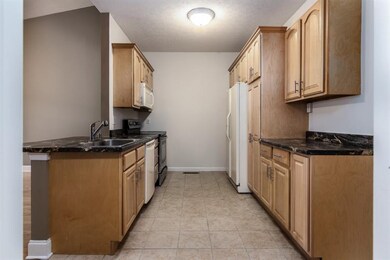 Fully equipped kitchen with ceramic tile flooring 