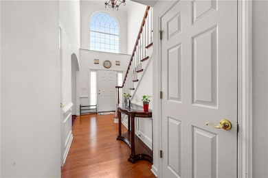 Entryway featuring stairway, arched walkways, wood