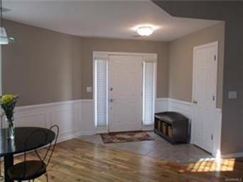 Foyer has tile flooring, new wood flooring in Dini