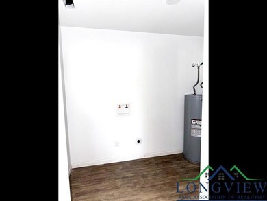 Washroom featuring laundry area, wood finished floors, electric water heater, hookup for an electric dryer, and washer hookup