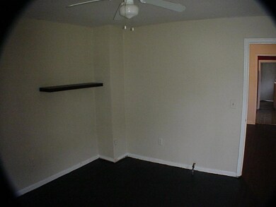 Spare room featuring a ceiling fan and baseboards