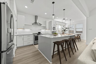 Kitchen with floating shelves and pendant lighting