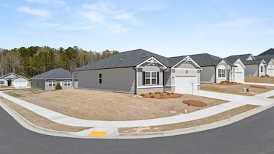 View of front of property with driveway, a residential view, a garage, and board and batten siding
