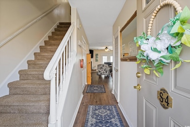 Foyer featuring stairs, dark wood finished floors,