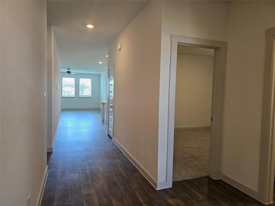 Corridor with dark wood-type flooring and recesse