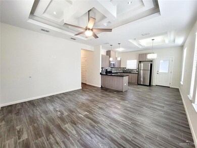 Kitchen with visible vents, dark wood finished floors, dark countertops, a tray ceiling, and stainless steel appliances