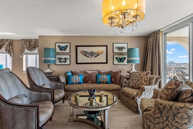 Living room featuring a chandelier, light hardwood