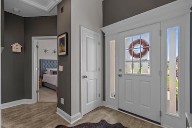 Foyer entrance featuring light wood-style floors and baseboards