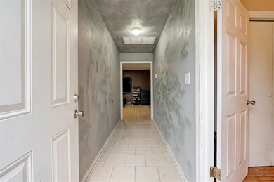 Hall featuring light tile flooring