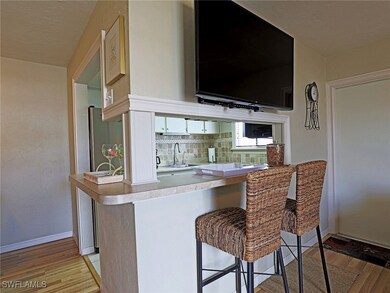 Bar area featuring light wood finished floors, a s