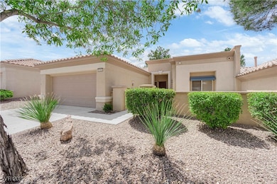 View of front of home with stucco siding, an attac