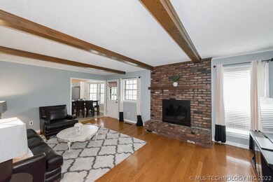 Family Room has Wood Burning Fireplace w/Glass Doo