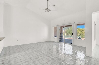 Spare room with high vaulted ceiling, ceiling fan, and crown molding