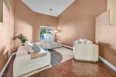 Living area with baseboards, wood finished floors,