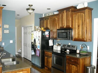 Kitchen boasts walnut cabinets and stainless appliances.