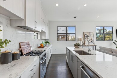 Kitchen with a wealth of natural light, sink, appl