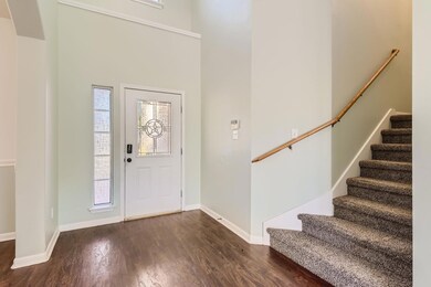 Foyer entrance featuring dark wood-style flooring