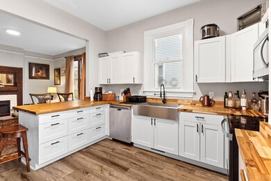 Butcher Block counters and ample white shaker cabinets