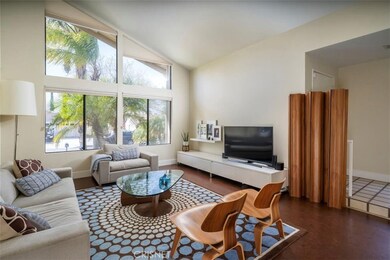 mid-century vibes in this open living room with cork floors and custom window coverings with multiple light options