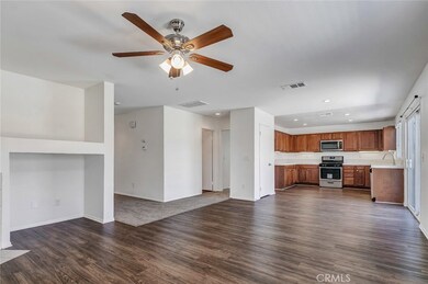 Family Room opening up to the kitchen, on the left is a full bathroom and bedroom