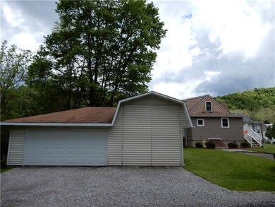 Three car detached garage has one bay large enough