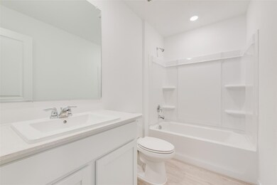 Full bathroom with hardwood / wood-style flooring,