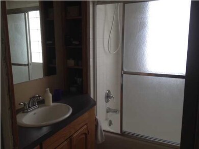 Bathroom is spacious and has built in shelving for