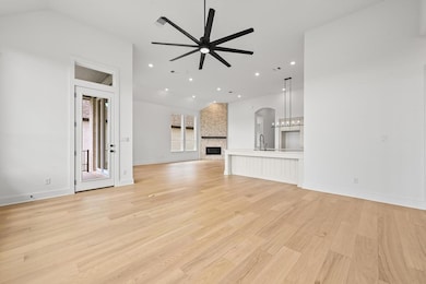 Unfurnished living room featuring a ceiling fan, 